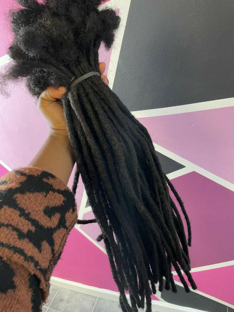 Artificial dreadlock extensions are pre-made dreadlock-like strands, typically made of synthetic hair, that are attached to natural hair to create the appearance of dreadlocks without the long-term co