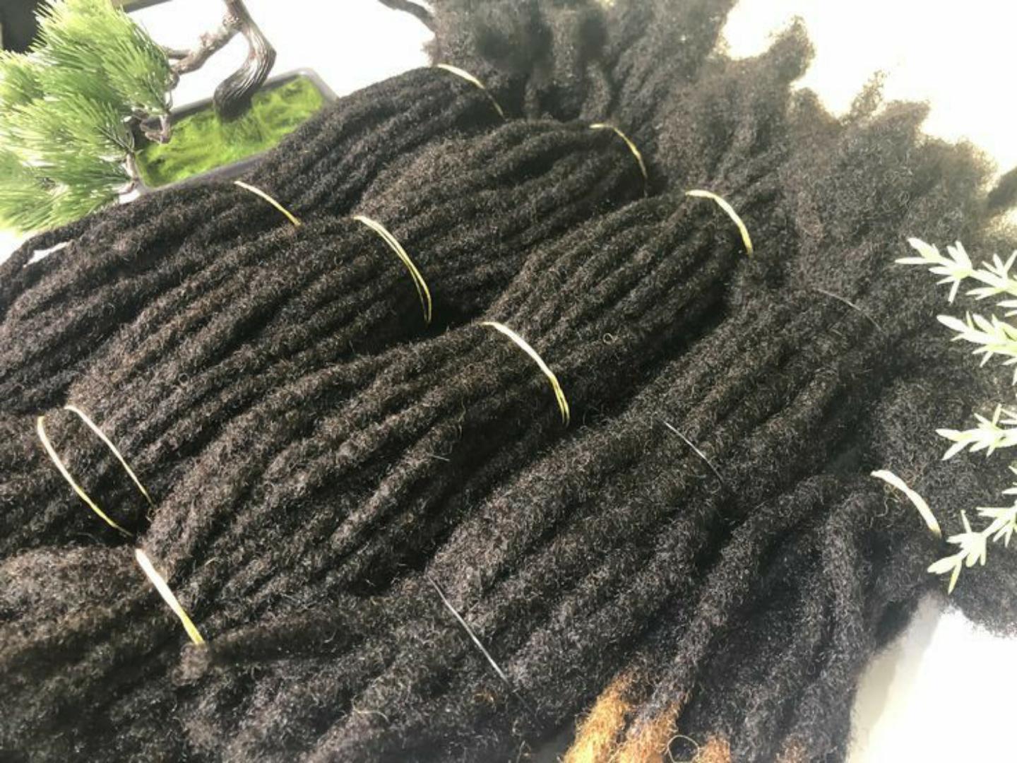 Artificial dreadlock extensions are pre-made dreadlock-like strands, typically made of synthetic hair, that are attached to natural hair to create the appearance of dreadlocks without the long-term co