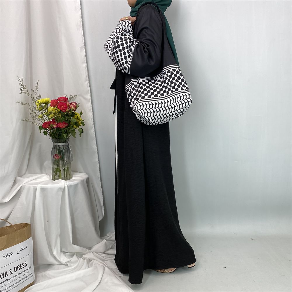 A new fashionable cardigan dress for Middle Eastern Muslims in Dubai, Turkey and Arabia during Ramadan, paired with a mini bag