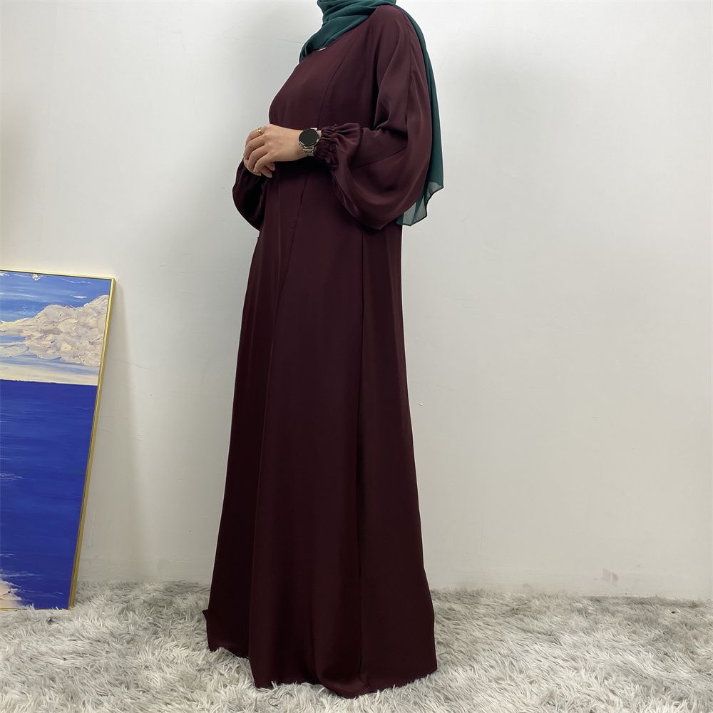 A slit, solid-color, one-shoulder sleeved Muslim dress is selling well in Dubai, Middle East