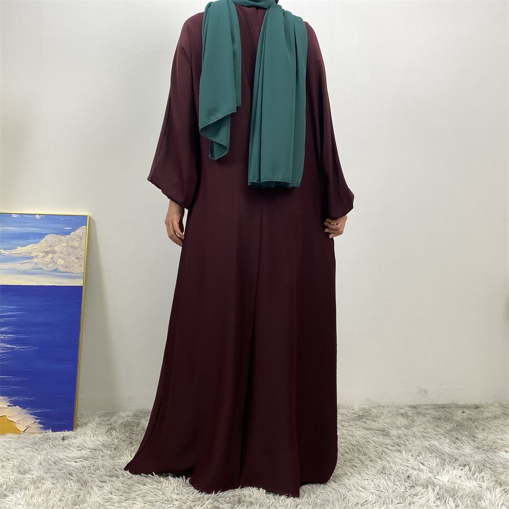A slit, solid-color, one-shoulder sleeved Muslim dress is selling well in Dubai, Middle East