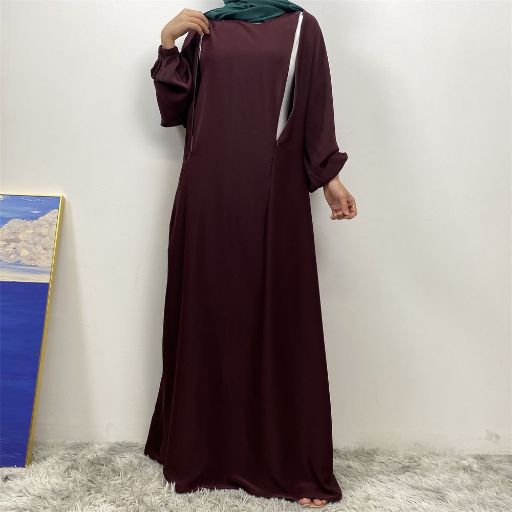 A slit, solid-color, one-shoulder sleeved Muslim dress is selling well in Dubai, Middle East