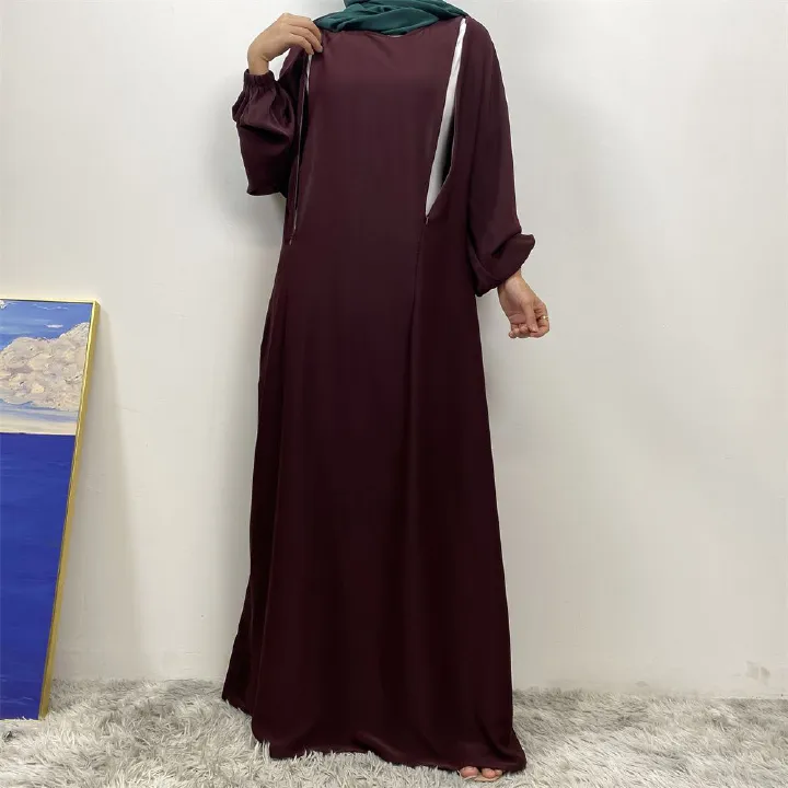 A slit, solid-color, one-shoulder sleeved Muslim dress is selling well in Dubai, Middle East