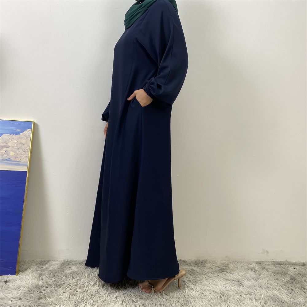A slit, solid-color, one-shoulder sleeved Muslim dress is selling well in Dubai, Middle East