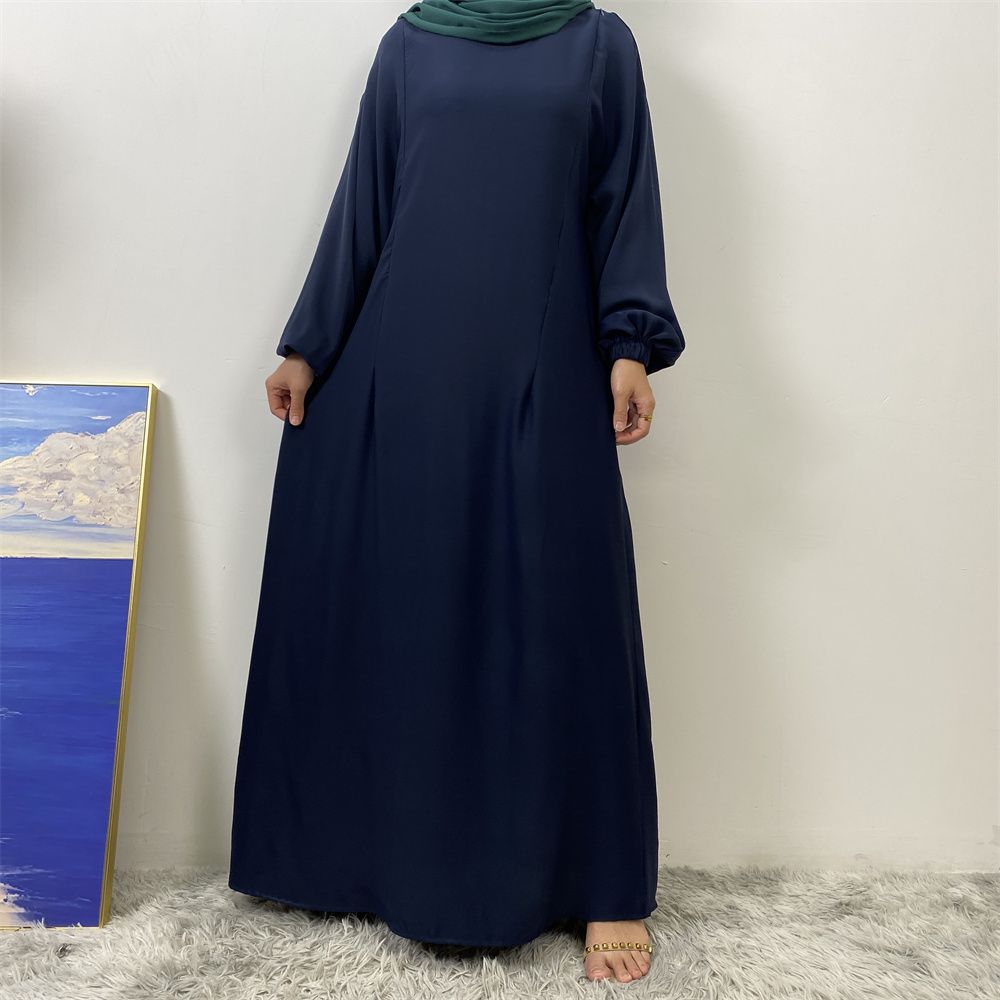 A slit, solid-color, one-shoulder sleeved Muslim dress is selling well in Dubai, Middle East