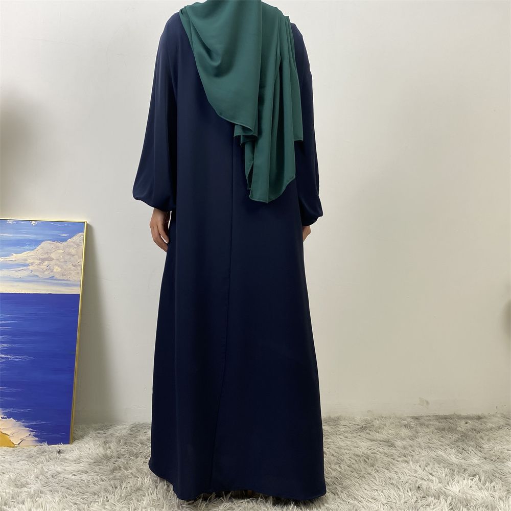 A slit, solid-color, one-shoulder sleeved Muslim dress is selling well in Dubai, Middle East