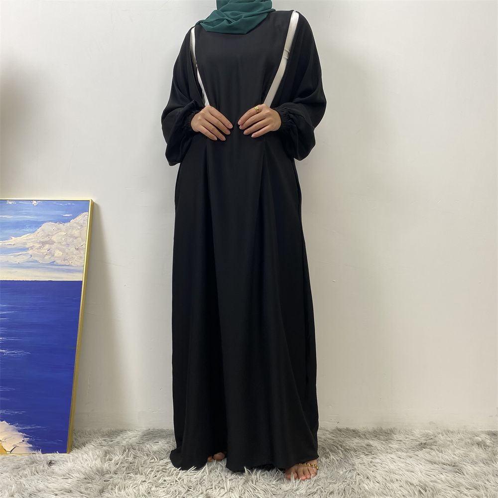 A slit, solid-color, one-shoulder sleeved Muslim dress is selling well in Dubai, Middle East