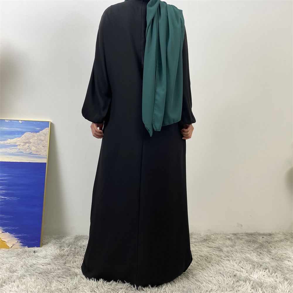 A slit, solid-color, one-shoulder sleeved Muslim dress is selling well in Dubai, Middle East