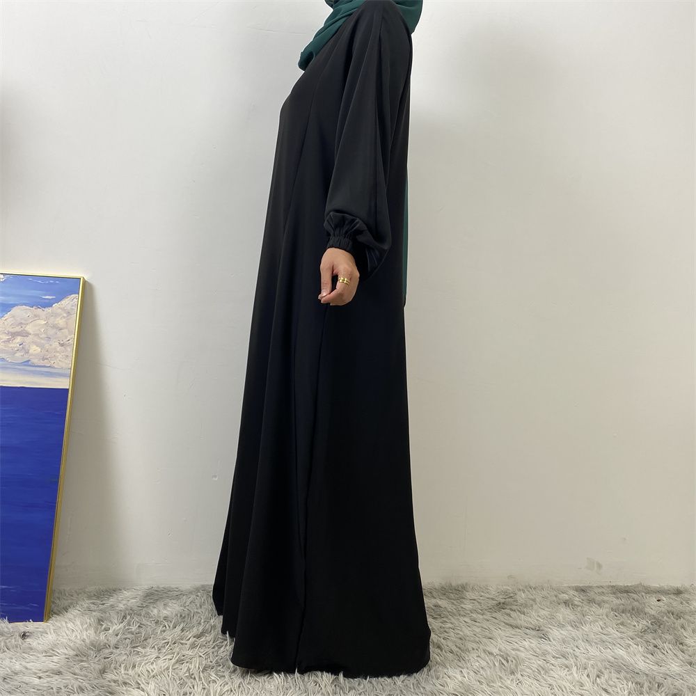 A slit, solid-color, one-shoulder sleeved Muslim dress is selling well in Dubai, Middle East