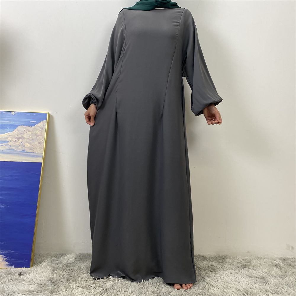 A slit, solid-color, one-shoulder sleeved Muslim dress is selling well in Dubai, Middle East