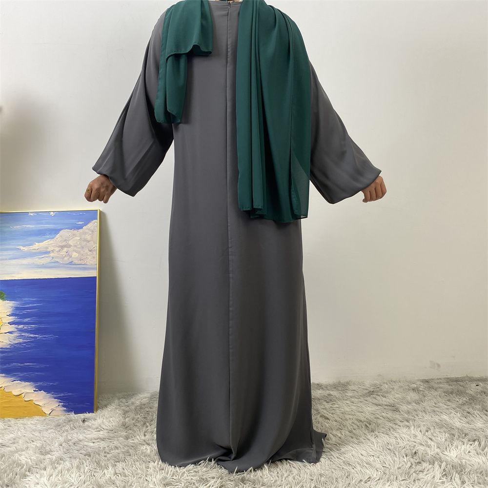 A slit, solid-color, one-shoulder sleeved Muslim dress is selling well in Dubai, Middle East
