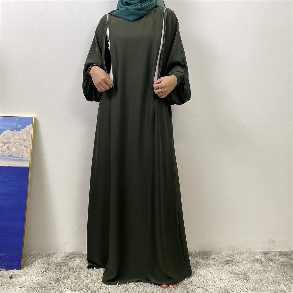 A slit, solid-color, one-shoulder sleeved Muslim dress is selling well in Dubai, Middle East