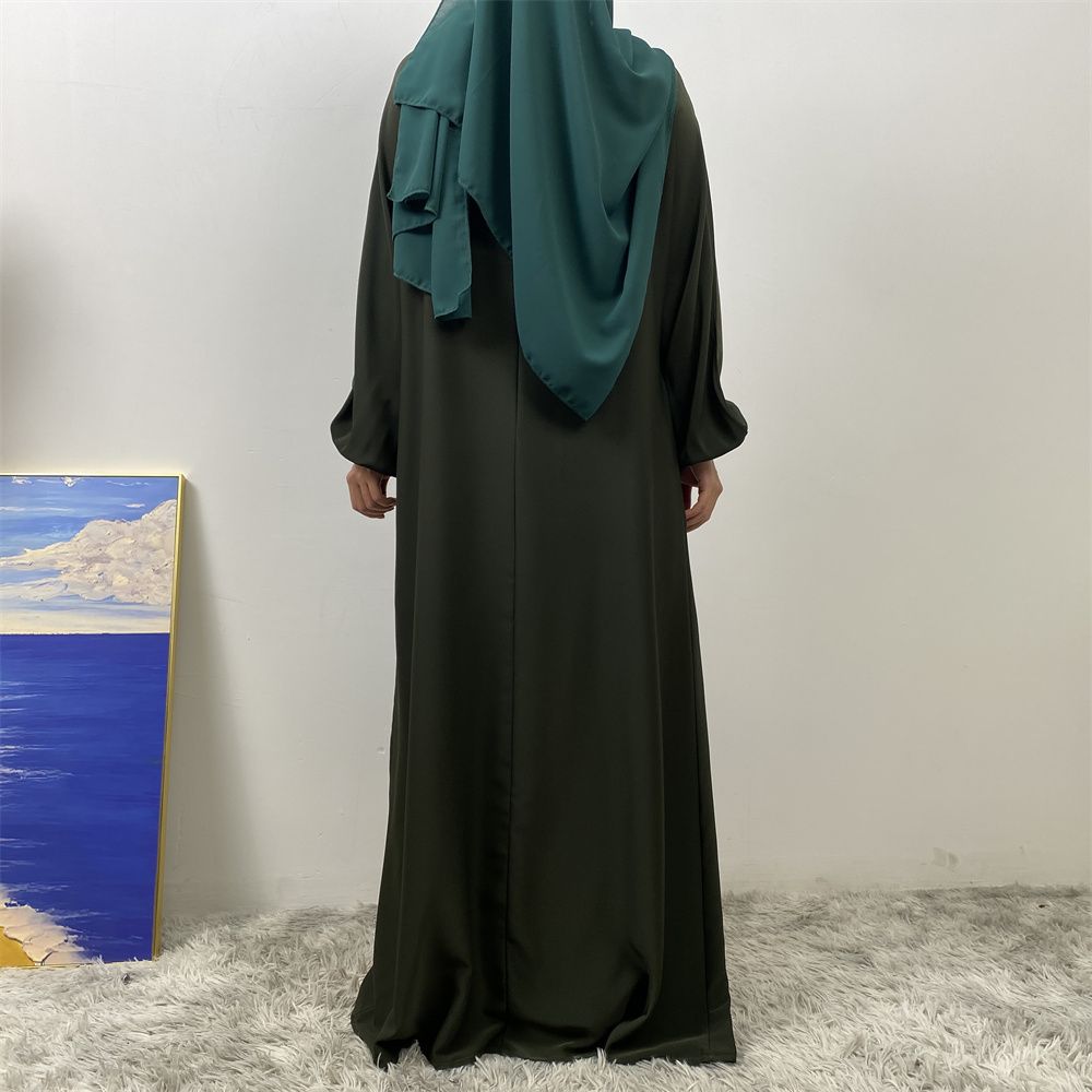 A slit, solid-color, one-shoulder sleeved Muslim dress is selling well in Dubai, Middle East