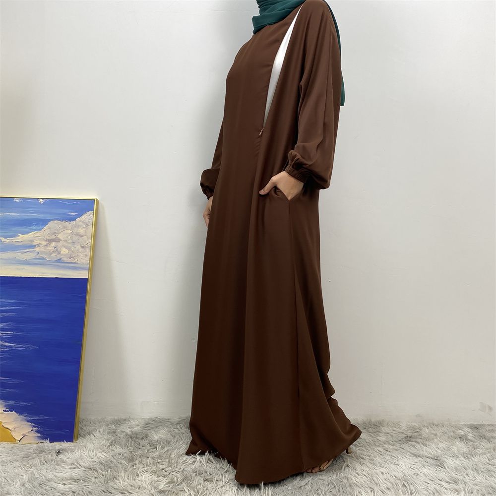 A slit, solid-color, one-shoulder sleeved Muslim dress is selling well in Dubai, Middle East