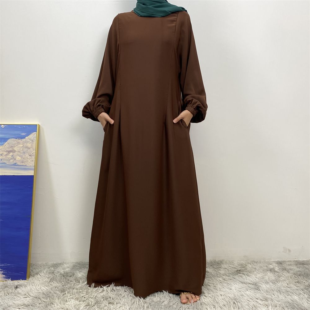 A slit, solid-color, one-shoulder sleeved Muslim dress is selling well in Dubai, Middle East