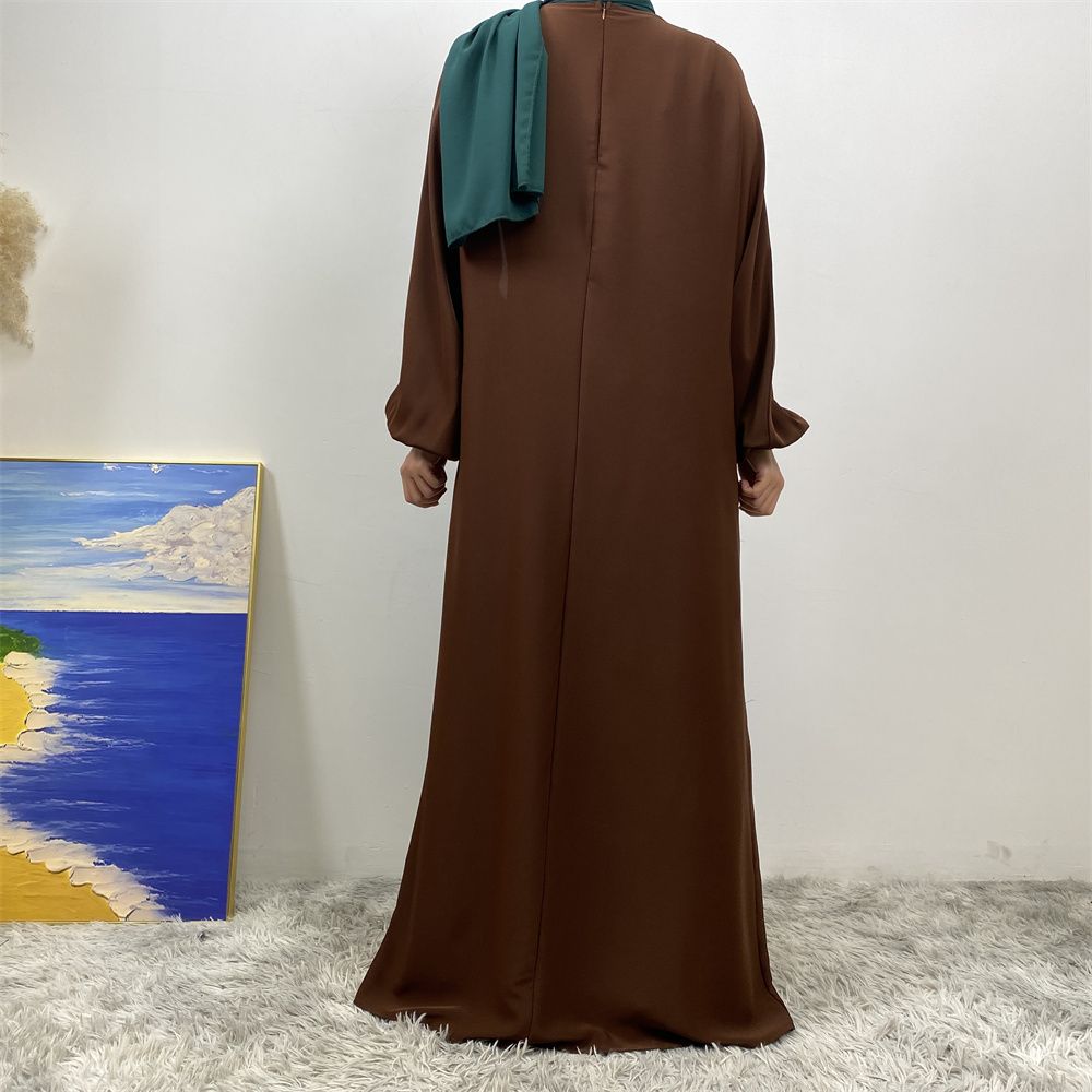 A slit, solid-color, one-shoulder sleeved Muslim dress is selling well in Dubai, Middle East