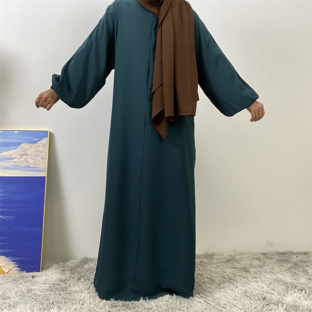 A slit, solid-color, one-shoulder sleeved Muslim dress is selling well in Dubai, Middle East