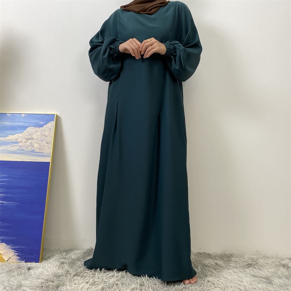 A slit, solid-color, one-shoulder sleeved Muslim dress is selling well in Dubai, Middle East