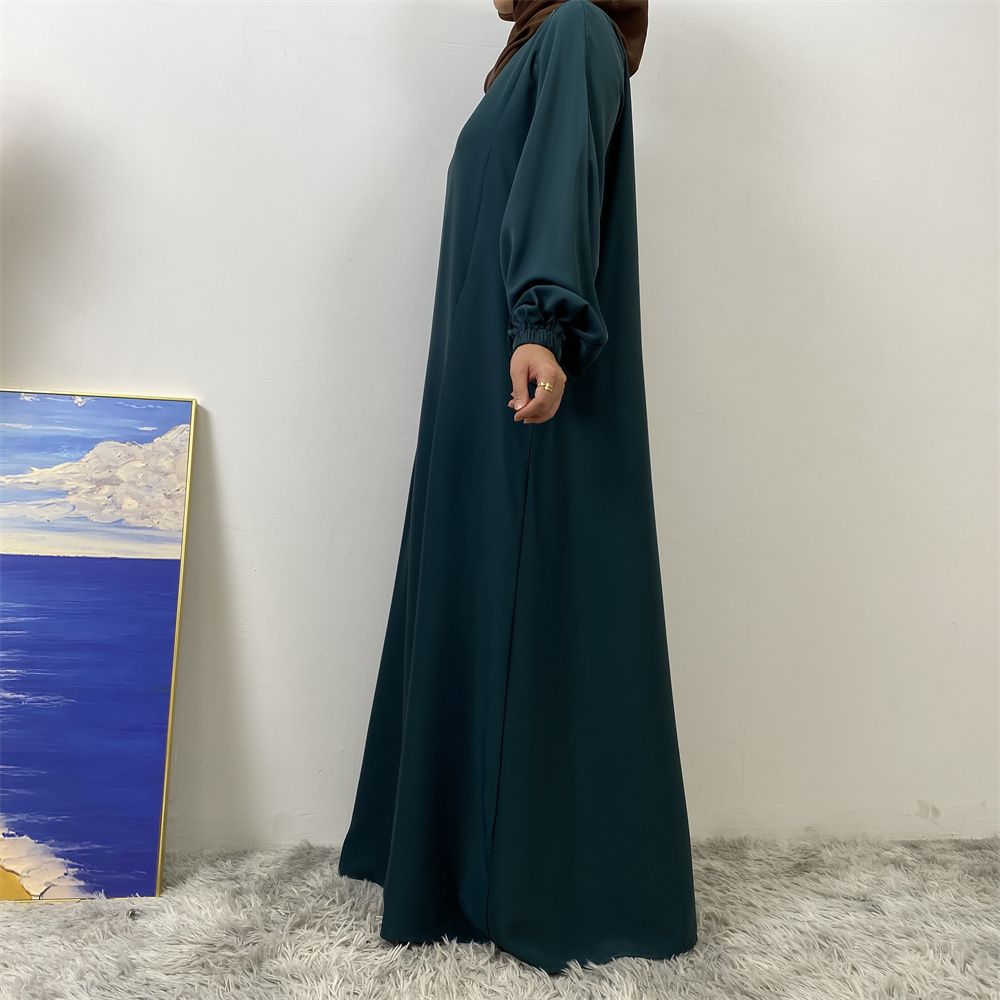 A slit, solid-color, one-shoulder sleeved Muslim dress is selling well in Dubai, Middle East