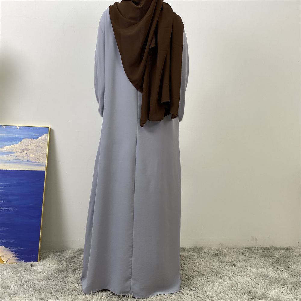 A slit, solid-color, one-shoulder sleeved Muslim dress is selling well in Dubai, Middle East