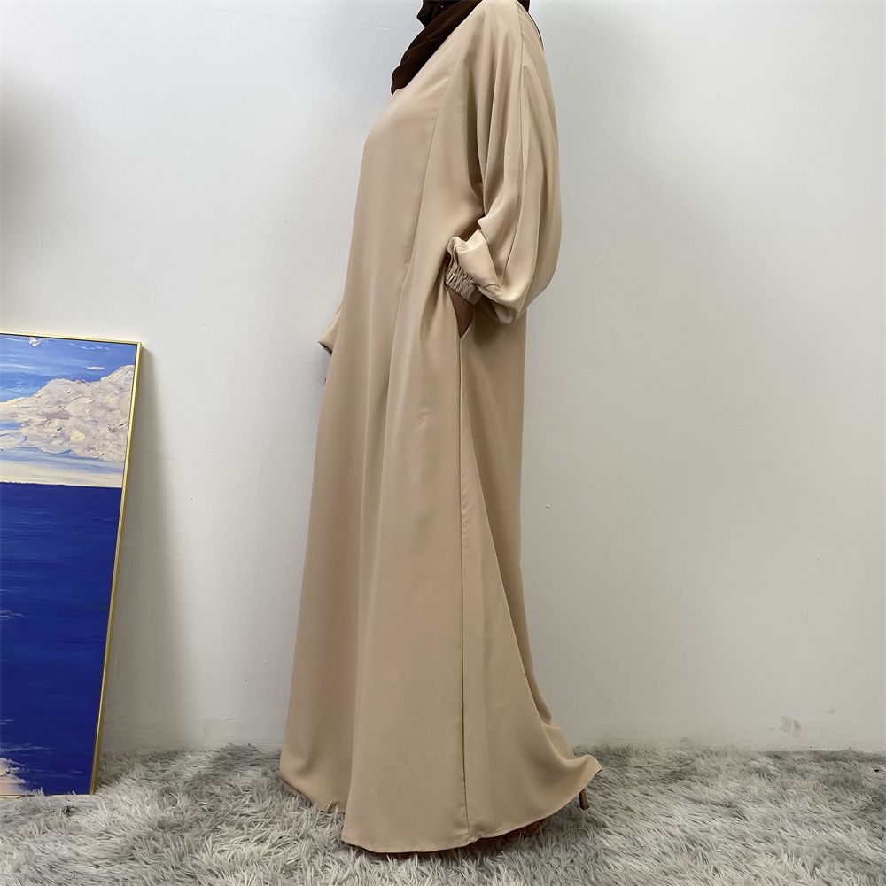 A slit, solid-color, one-shoulder sleeved Muslim dress is selling well in Dubai, Middle East