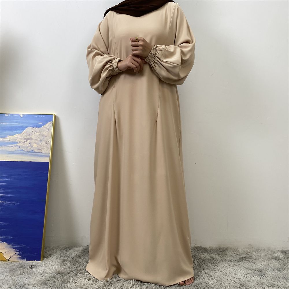 A slit, solid-color, one-shoulder sleeved Muslim dress is selling well in Dubai, Middle East