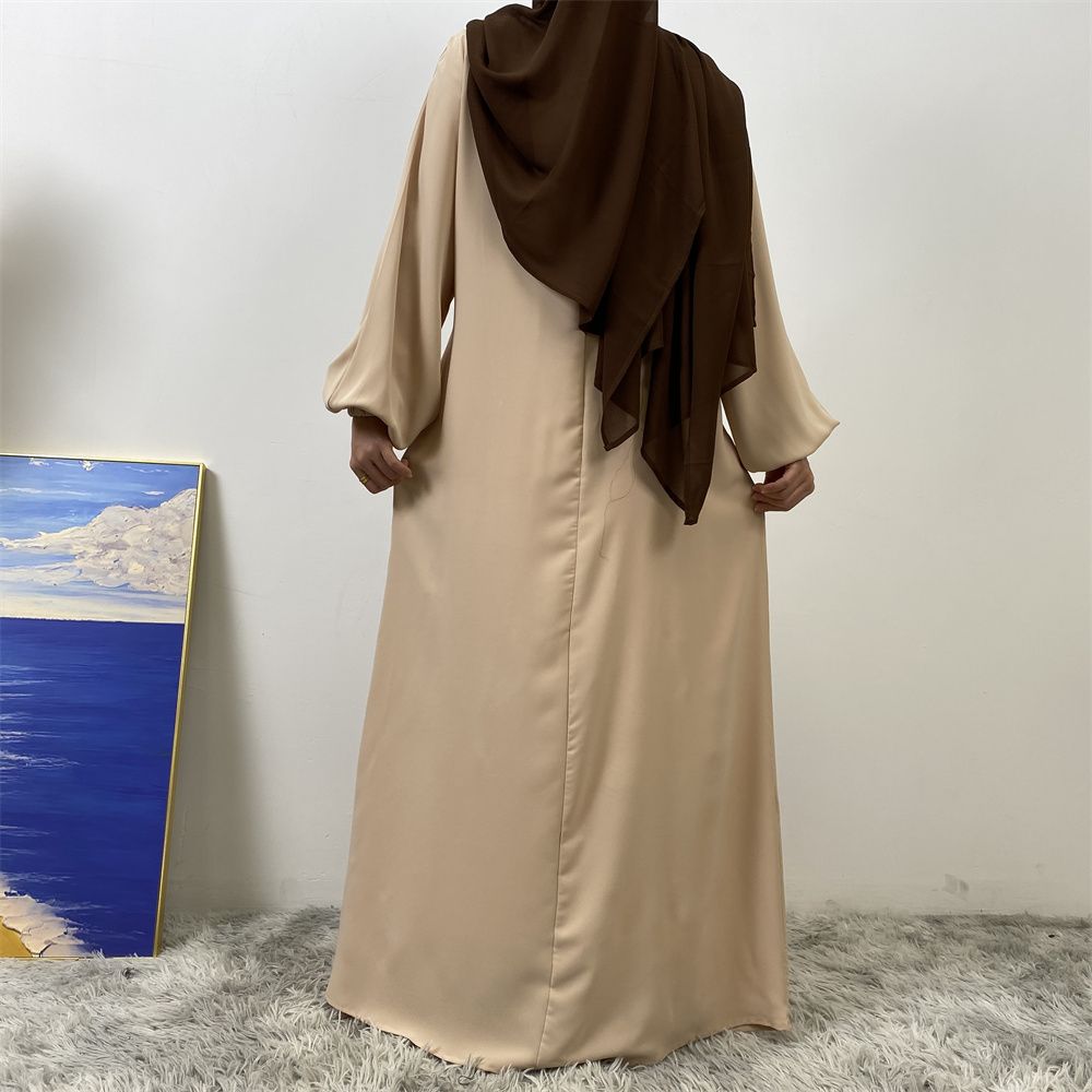 A slit, solid-color, one-shoulder sleeved Muslim dress is selling well in Dubai, Middle East