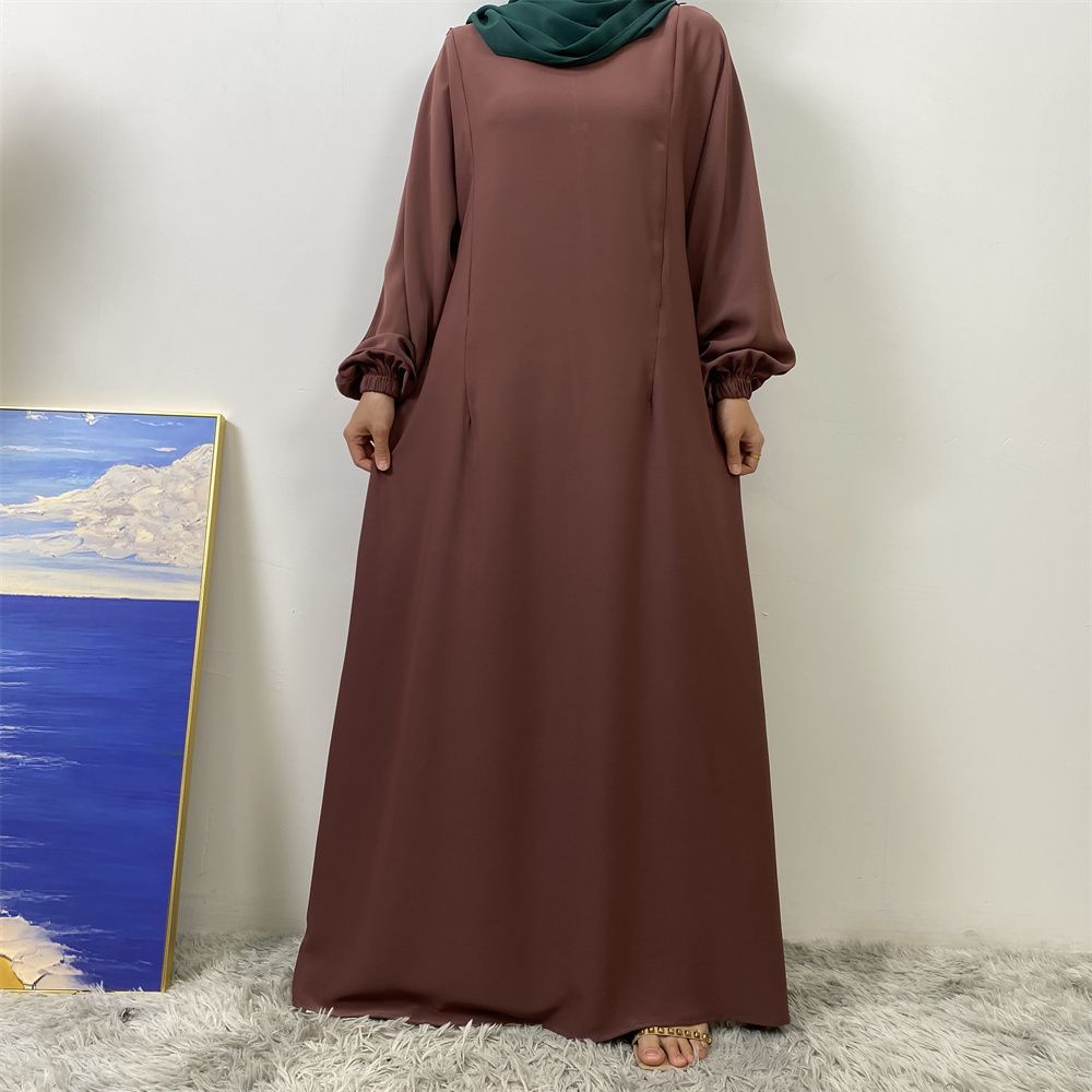 A slit, solid-color, one-shoulder sleeved Muslim dress is selling well in Dubai, Middle East