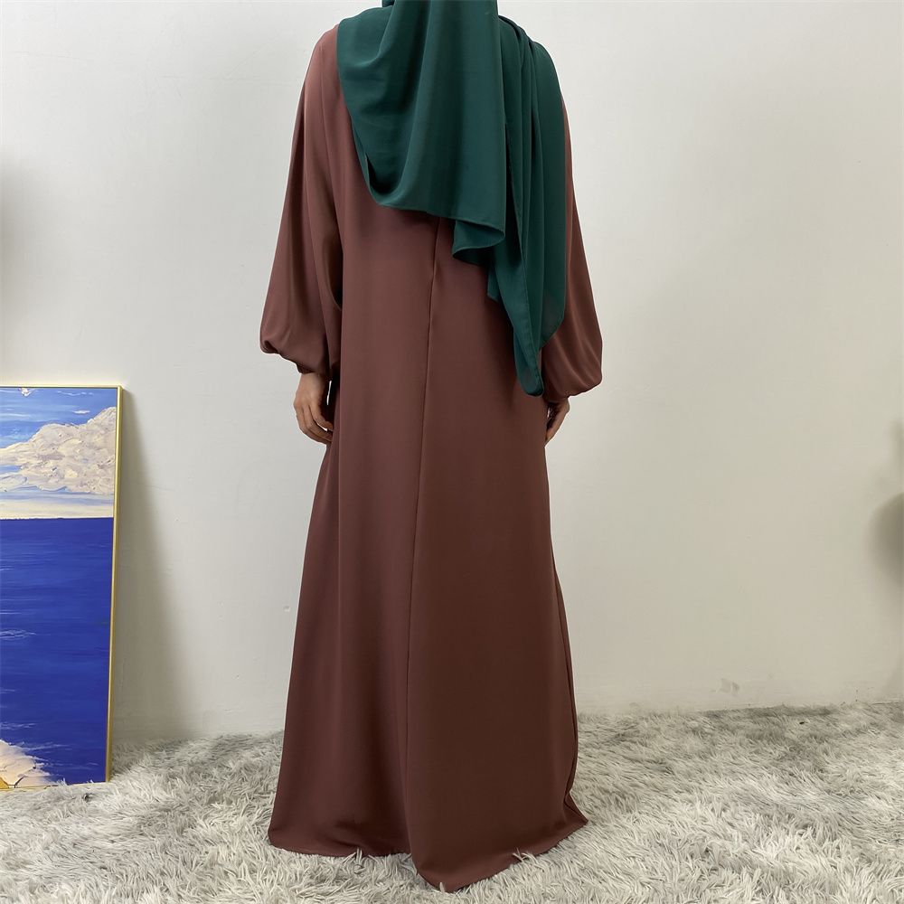 A slit, solid-color, one-shoulder sleeved Muslim dress is selling well in Dubai, Middle East