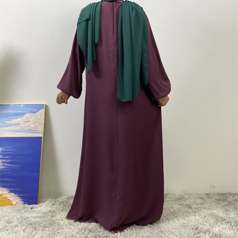 A slit, solid-color, one-shoulder sleeved Muslim dress is selling well in Dubai, Middle East