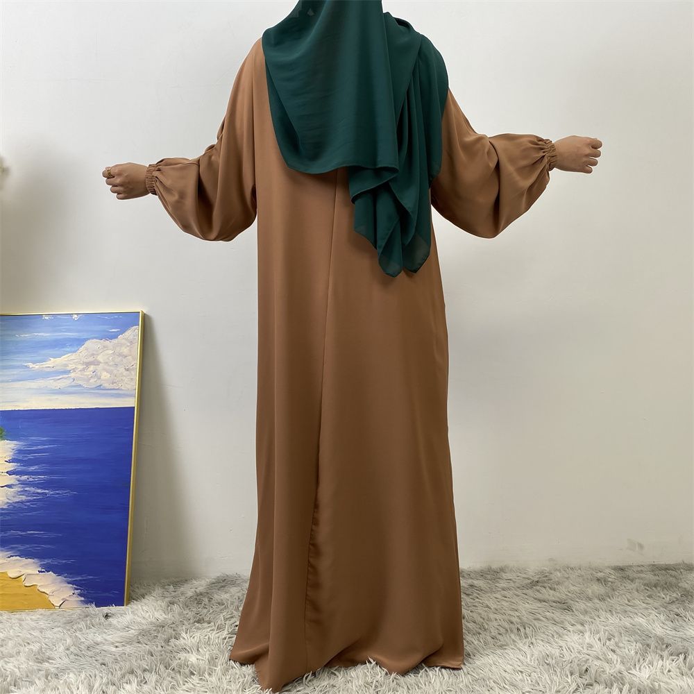 A slit, solid-color, one-shoulder sleeved Muslim dress is selling well in Dubai, Middle East