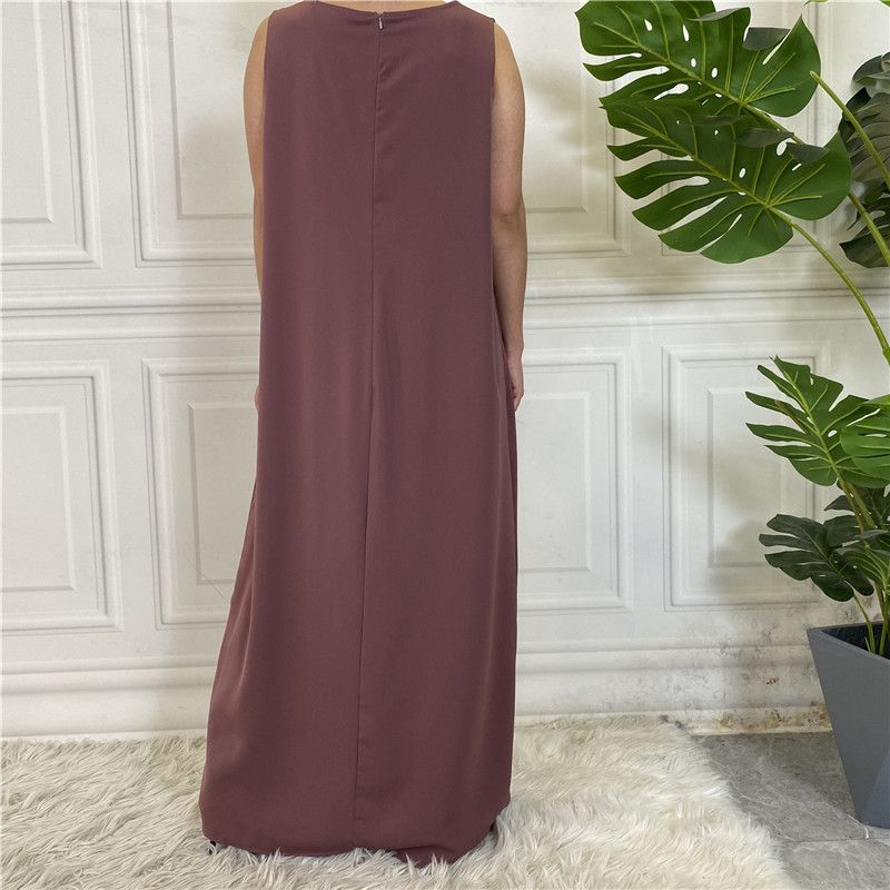 A new Muslim dress with a simple sleeveless base made of plain Nida fabric, which is selling well in the Middle East, Dubai, Arab and African regions