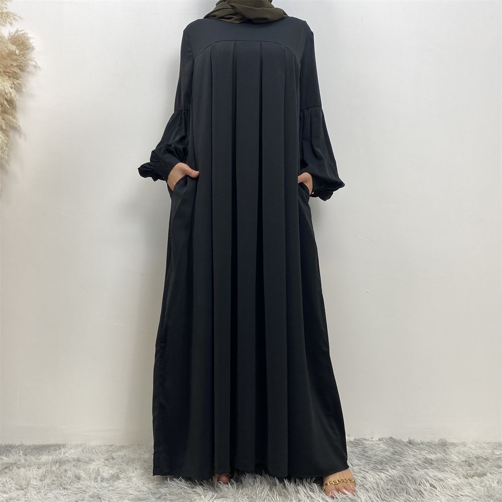 n with poThe new Middle Eastern Muslim women's round-neck abaya dress, an elegant solid-color summer pleated dress for Islamic womeckets