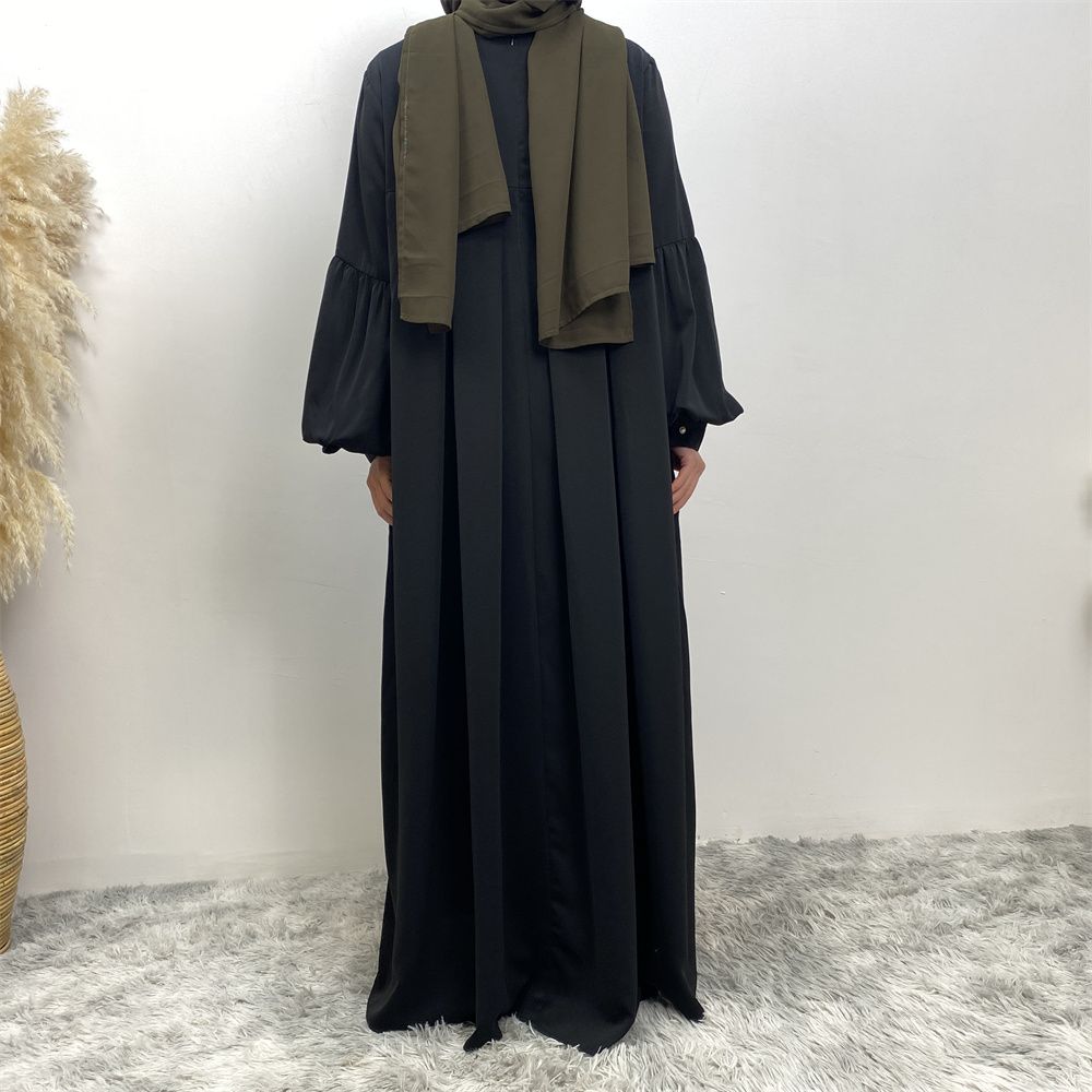 n with poThe new Middle Eastern Muslim women's round-neck abaya dress, an elegant solid-color summer pleated dress for Islamic womeckets