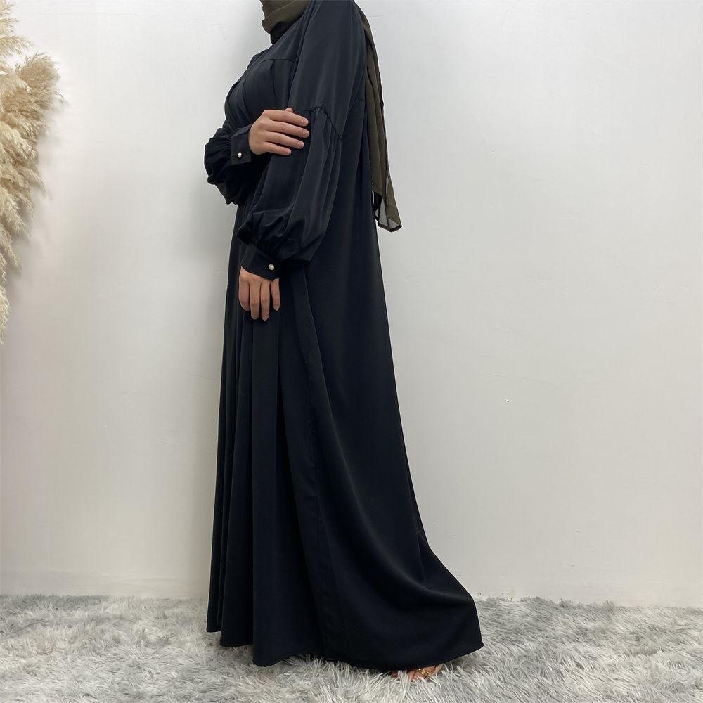 n with poThe new Middle Eastern Muslim women's round-neck abaya dress, an elegant solid-color summer pleated dress for Islamic womeckets
