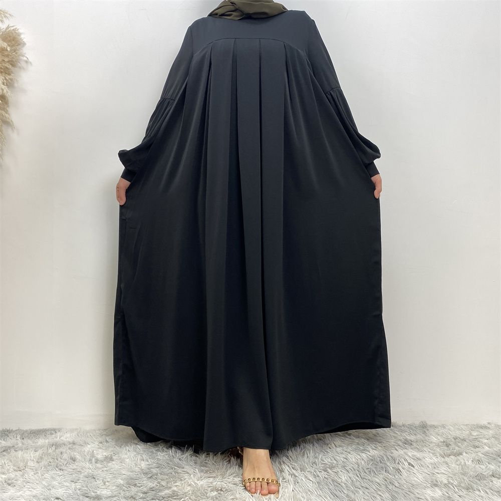 n with poThe new Middle Eastern Muslim women's round-neck abaya dress, an elegant solid-color summer pleated dress for Islamic womeckets
