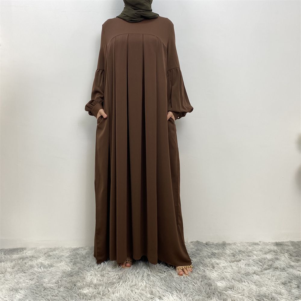 n with poThe new Middle Eastern Muslim women's round-neck abaya dress, an elegant solid-color summer pleated dress for Islamic womeckets