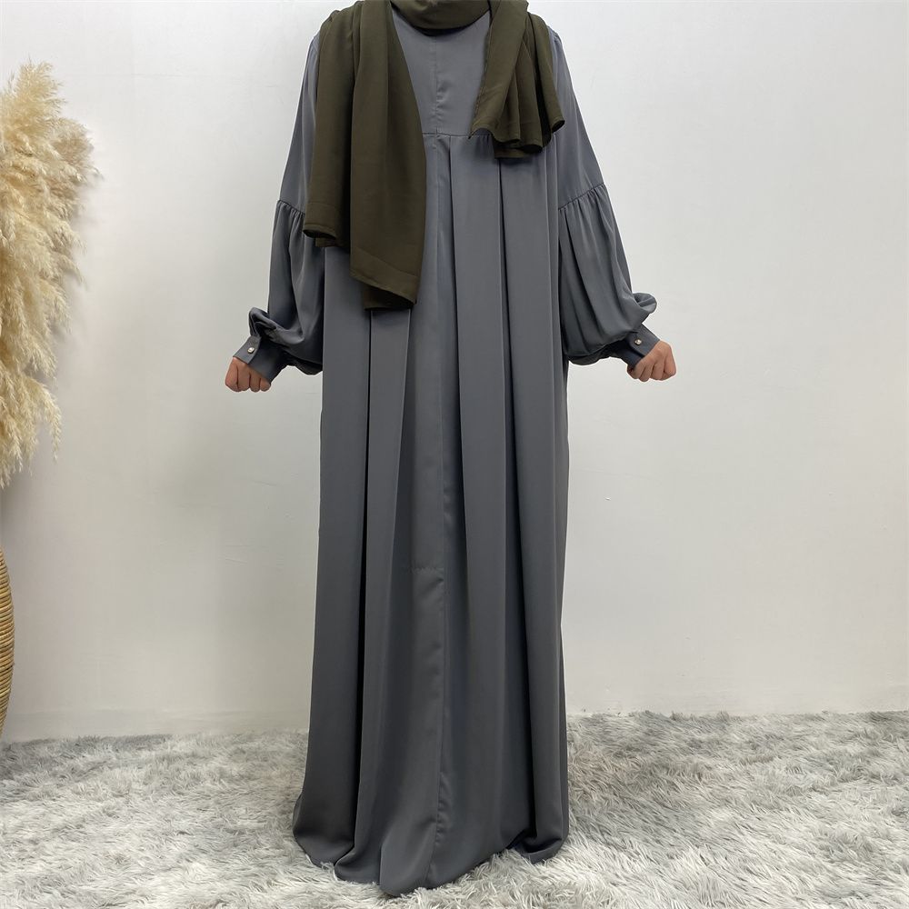 n with poThe new Middle Eastern Muslim women's round-neck abaya dress, an elegant solid-color summer pleated dress for Islamic womeckets