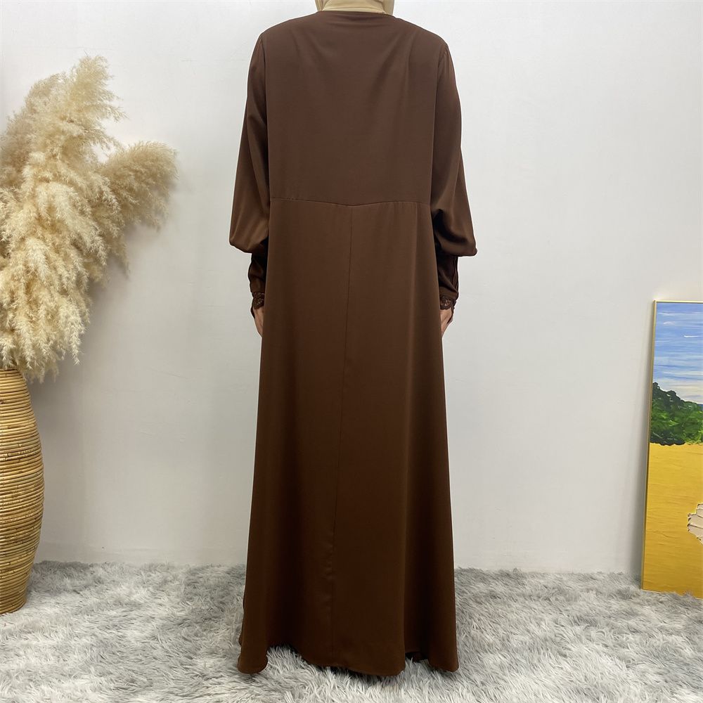 A simple and luxurious Muslim Middle Eastern woman's dress with lace zippers, an Islamic Turkish pleated front zipper, and an Arab Turkish cardigan robe