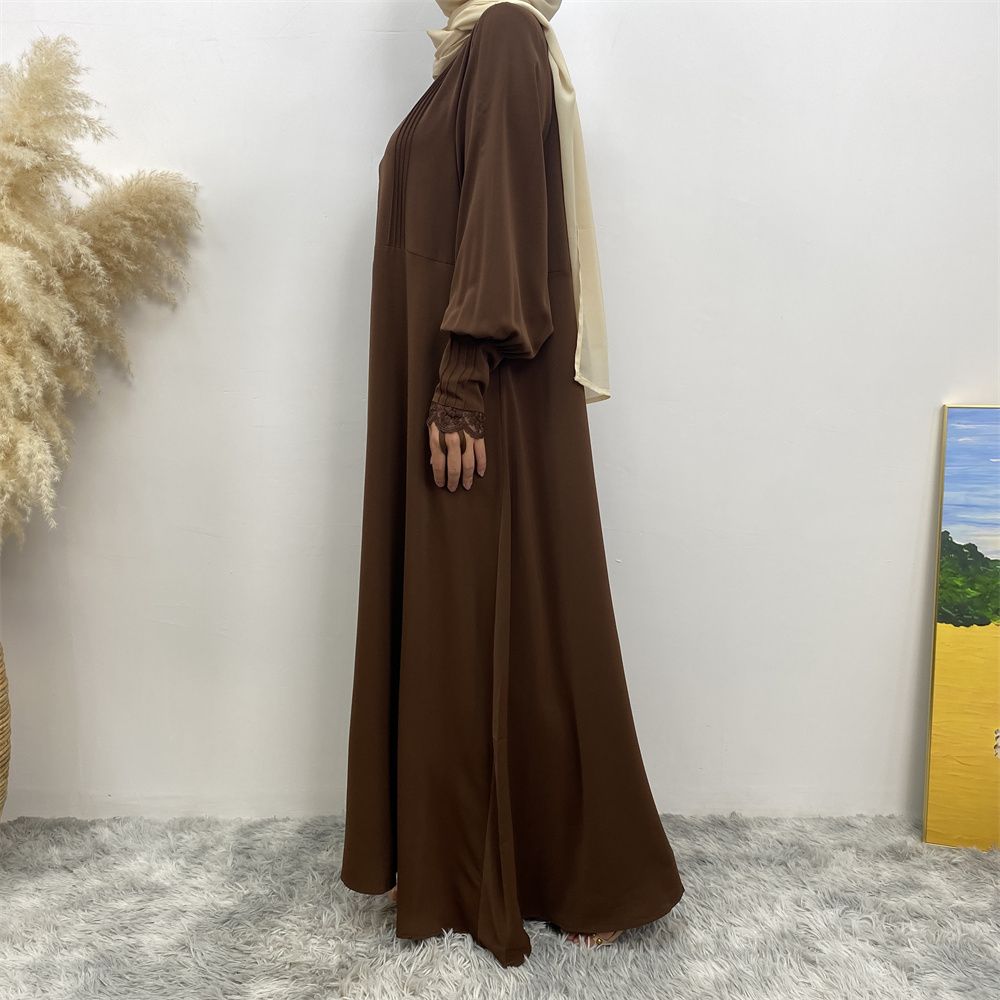 A simple and luxurious Muslim Middle Eastern woman's dress with lace zippers, an Islamic Turkish pleated front zipper, and an Arab Turkish cardigan robe