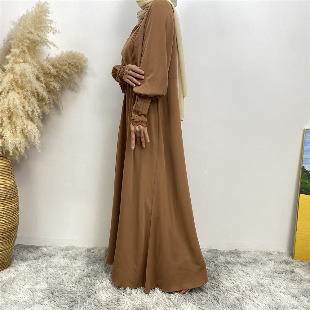 A simple and luxurious Muslim Middle Eastern woman's dress with lace zippers, an Islamic Turkish pleated front zipper, and an Arab Turkish cardigan robe