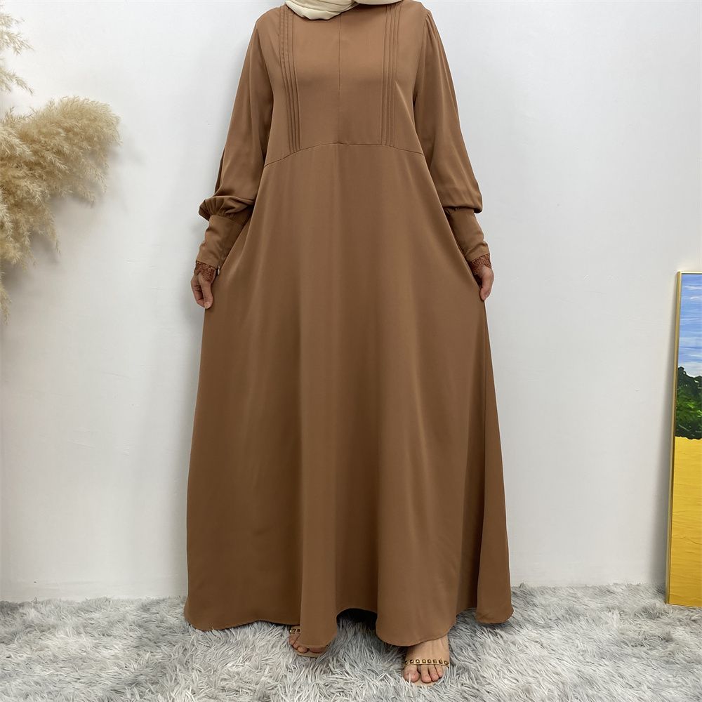 A simple and luxurious Muslim Middle Eastern woman's dress with lace zippers, an Islamic Turkish pleated front zipper, and an Arab Turkish cardigan robe