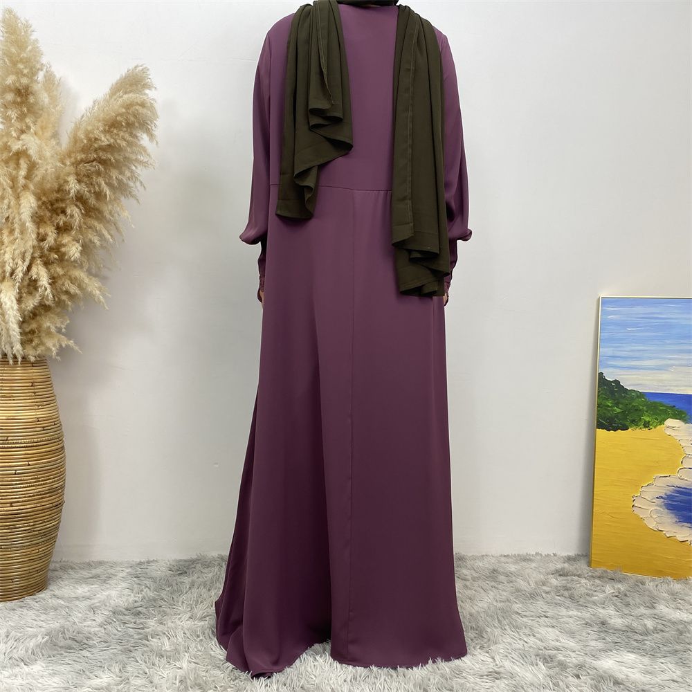 A simple and luxurious Muslim Middle Eastern woman's dress with lace zippers, an Islamic Turkish pleated front zipper, and an Arab Turkish cardigan robe