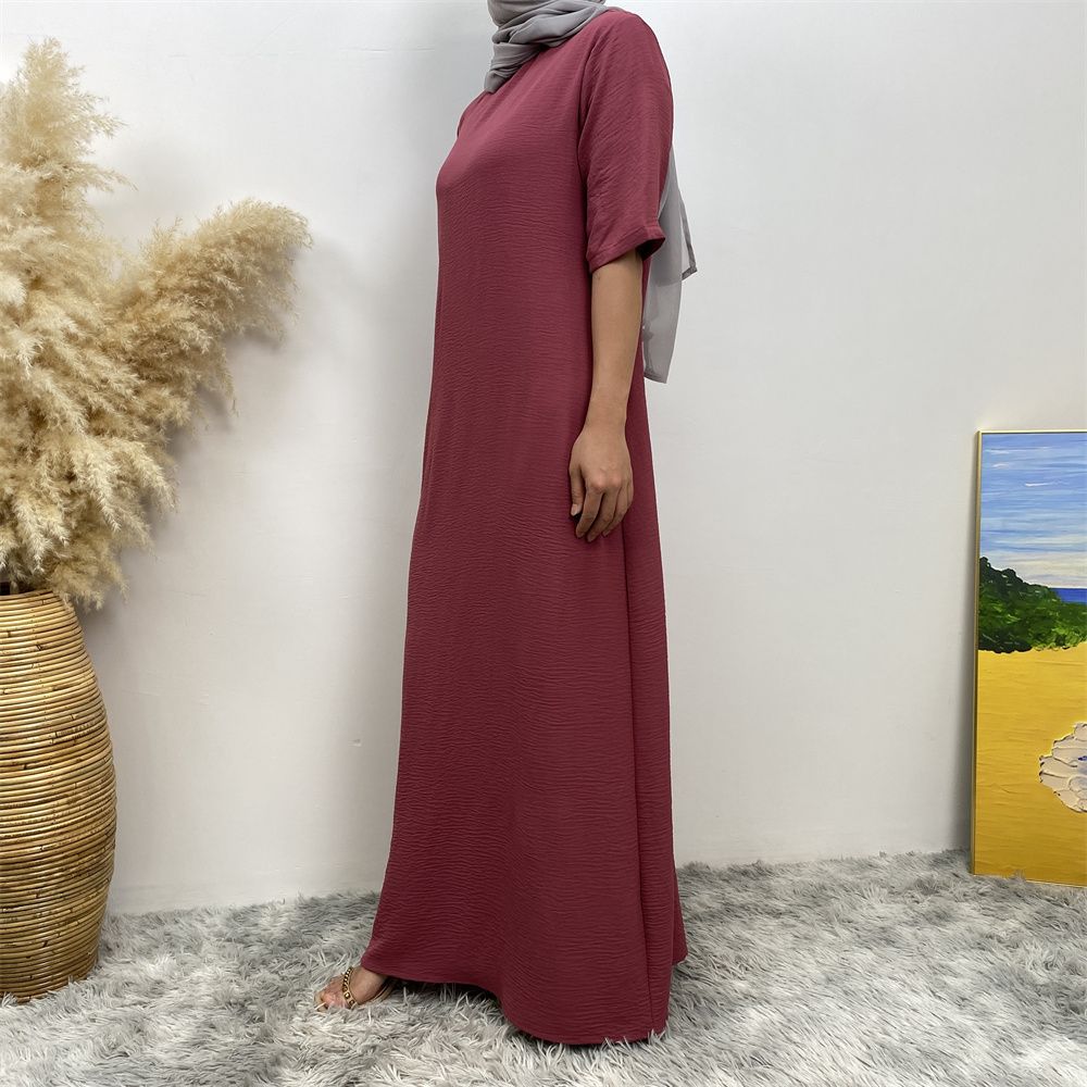 Muslim fashion: A simple, plain-colored mid-sleeved dress in Dubai, Middle East, and elegant women's clothing from Africa, Arabia and Turkey