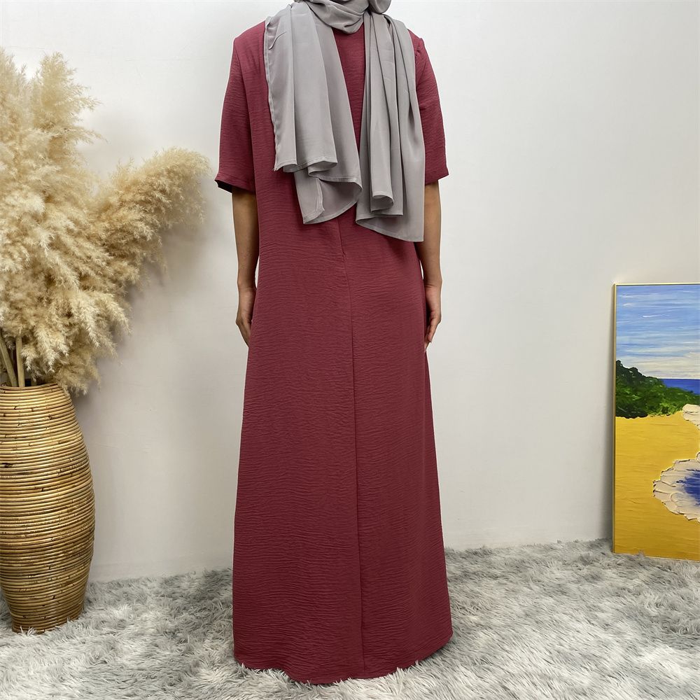 Muslim fashion: A simple, plain-colored mid-sleeved dress in Dubai, Middle East, and elegant women's clothing from Africa, Arabia and Turkey