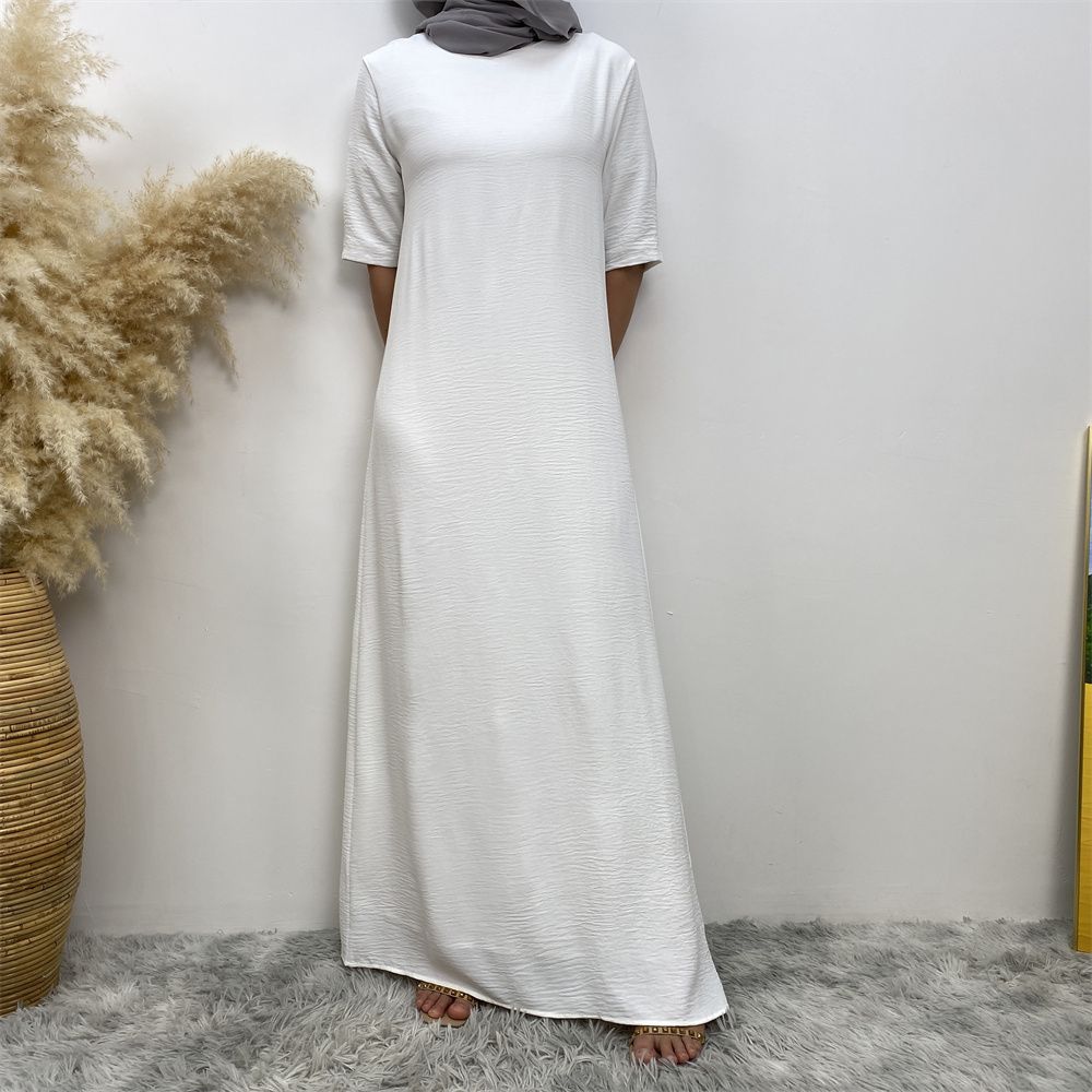 Muslim fashion: A simple, plain-colored mid-sleeved dress in Dubai, Middle East, and elegant women's clothing from Africa, Arabia and Turkey
