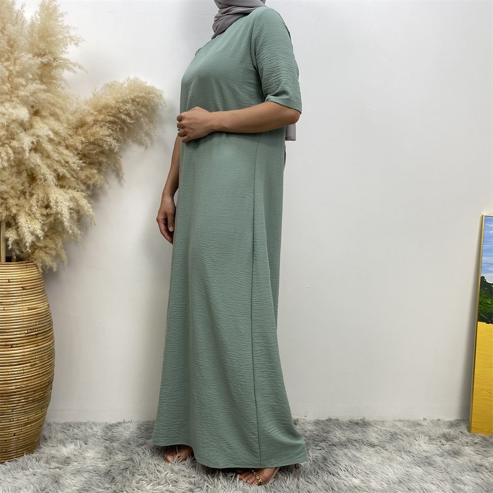 Muslim fashion: A simple, plain-colored mid-sleeved dress in Dubai, Middle East, and elegant women's clothing from Africa, Arabia and Turkey