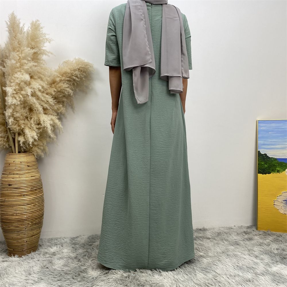 Muslim fashion: A simple, plain-colored mid-sleeved dress in Dubai, Middle East, and elegant women's clothing from Africa, Arabia and Turkey