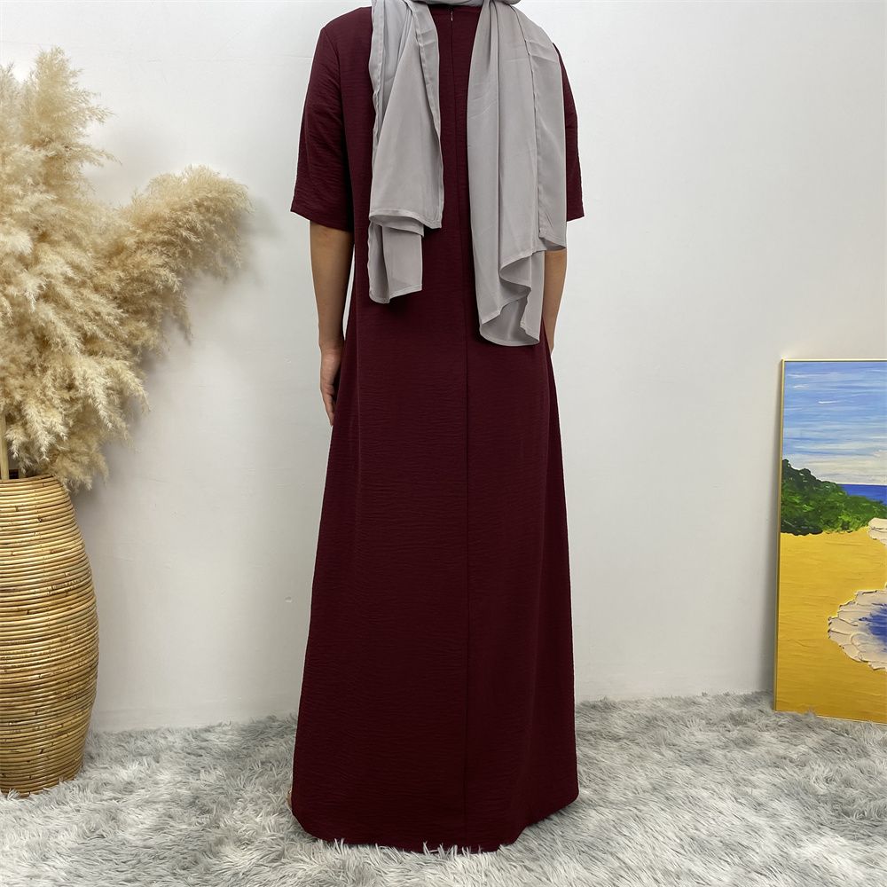 Muslim fashion: A simple, plain-colored mid-sleeved dress in Dubai, Middle East, and elegant women's clothing from Africa, Arabia and Turkey