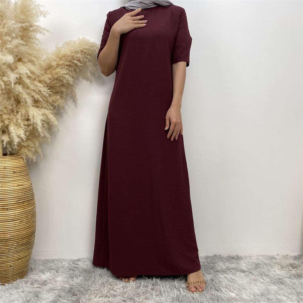 Muslim fashion: A simple, plain-colored mid-sleeved dress in Dubai, Middle East, and elegant women's clothing from Africa, Arabia and Turkey